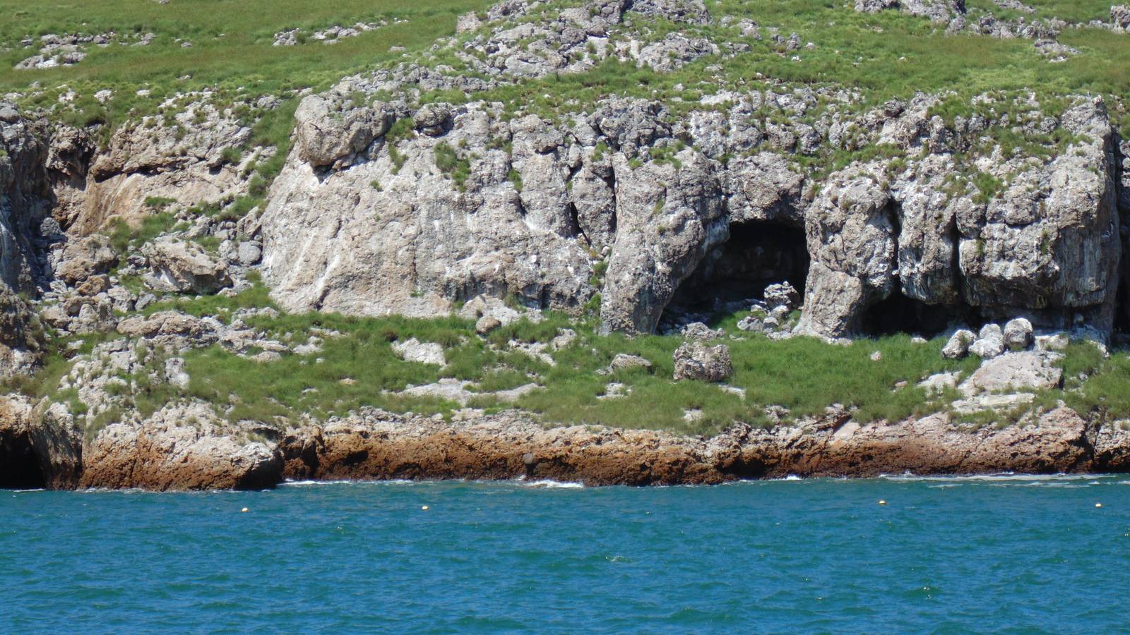 Rocky cliffs and sea caves on the Marietas Islands, seen from a boat