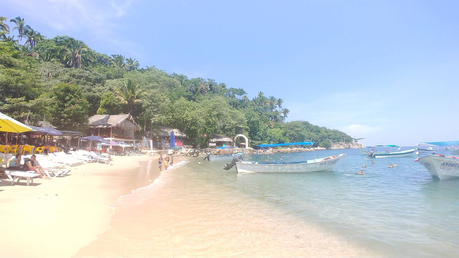 Palapa restaurants and fishing boats on Mismaloya beach
